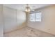 Neutral bedroom featuring carpet, ceiling fan, and large window, offering a bright, airy space at 8225 N Central Ave # 44, Phoenix, AZ 85020