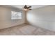 Bedroom with neutral walls and flooring, natural light from window, ceiling fan and overhead lighting at 8225 N Central Ave # 44, Phoenix, AZ 85020