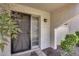 Exterior front door showing porch with dark metal door and small porch light at 8225 N Central Ave # 44, Phoenix, AZ 85020