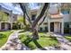 Inviting home with green grass, walkway, mature shade tree, and second story balcony at 8225 N Central Ave # 44, Phoenix, AZ 85020