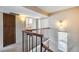 Upstairs hallway with decorative railing, and neutral walls, leading to a bathroom and a bedroom at 8225 N Central Ave # 44, Phoenix, AZ 85020