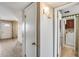 Hallway view leading to a laundry room and a living room with white painted walls at 8225 N Central Ave # 44, Phoenix, AZ 85020