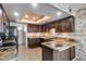 Well-appointed kitchen with granite counters, dark wood cabinets, and modern appliances at 8225 N Central Ave # 44, Phoenix, AZ 85020