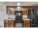 Well-lit kitchen features modern appliances with dark wood cabinets and granite countertops at 8225 N Central Ave # 44, Phoenix, AZ 85020