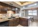 Updated kitchen with granite countertops, dark wood cabinets, and black appliances at 8225 N Central Ave # 44, Phoenix, AZ 85020