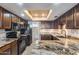 Spacious kitchen featuring granite countertops, black appliances, and recessed lighting at 8225 N Central Ave # 44, Phoenix, AZ 85020