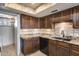 Updated kitchen with granite countertops, dark wood cabinets, and under-cabinet lighting at 8225 N Central Ave # 44, Phoenix, AZ 85020