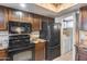 A modern kitchen with black appliances including a microwave, range, and refrigerator at 8225 N Central Ave # 44, Phoenix, AZ 85020