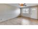 Bright living room with tile floors, ceiling fan, neutral paint and a front door at 8225 N Central Ave # 44, Phoenix, AZ 85020