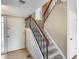 Stairwell with carpeted stairs, wooden banister, and view to front door at 8225 N Central Ave # 44, Phoenix, AZ 85020