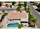 Aerial view of the property featuring backyard pool, covered patio, and desert landscaping at 843 E Vera Ln, Tempe, AZ 85284