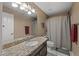 Bathroom featuring granite countertops, tile floors, and a shower-tub combo with a curtain at 843 E Vera Ln, Tempe, AZ 85284