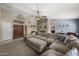 Inviting living room with a comfortable sectional sofa, double doors and stylish decor at 843 E Vera Ln, Tempe, AZ 85284