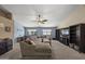 Cozy living room featuring comfortable sectional sofa, fan, and neutral tones at 843 E Vera Ln, Tempe, AZ 85284