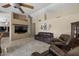 Comfortable living room with plush leather seating, a large TV, and cozy, neutral decor at 843 E Vera Ln, Tempe, AZ 85284