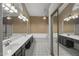 Luxurious main bathroom featuring double sinks, vanities, and mirrored wall at 843 E Vera Ln, Tempe, AZ 85284