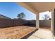Spacious backyard featuring a concrete patio and block wall, perfect for outdoor entertaining at 8679 W Raven Dr, Arizona City, AZ 85123