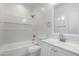 Bright bathroom featuring a shower and tub combination with white tile, a vanity with a sink, and a mirror at 8679 W Raven Dr, Arizona City, AZ 85123