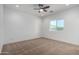 Comfortable bedroom has neutral carpeting, a ceiling fan, and a window that filters natural light in the room at 8679 W Raven Dr, Arizona City, AZ 85123