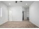 Well-lit bedroom with carpet, offering access to a walk-in closet and other rooms, enhanced by neutral tones at 8679 W Raven Dr, Arizona City, AZ 85123