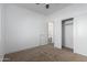 Bedroom featuring a carpeted floor, entry door, closet, and modern ceiling fan at 8679 W Raven Dr, Arizona City, AZ 85123