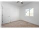 Well-lit bedroom with a neutral carpet, window, and a door with a silver handle at 8679 W Raven Dr, Arizona City, AZ 85123
