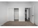 Carpeted bedroom featuring sliding closet doors and a bathroom entrance, designed for practicality and ease of living at 8679 W Raven Dr, Arizona City, AZ 85123