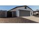 Charming single-story home featuring gray 2-car garage, gravel landscaping, and modern design at 8679 W Raven Dr, Arizona City, AZ 85123