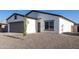 Charming single-story home featuring gray 2-car garage, gravel landscaping, and modern design at 8679 W Raven Dr, Arizona City, AZ 85123