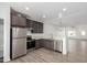 Modern kitchen features stainless appliances, gray cabinets, and sleek countertops, open to the dining area at 8679 W Raven Dr, Arizona City, AZ 85123