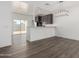 Modern kitchen featuring stainless steel appliances, breakfast bar, pendant lighting, and wood-look floors at 8679 W Raven Dr, Arizona City, AZ 85123