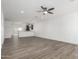 Bright, open-concept living room with wood-look floors, recessed lighting, and neutral color palette at 8679 W Raven Dr, Arizona City, AZ 85123