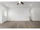 Bright, open-concept living room with wood-look floors, recessed lighting, and neutral color palette at 8679 W Raven Dr, Arizona City, AZ 85123