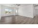 Bright, open-concept living room with wood-look floors, recessed lighting, and neutral color palette at 8679 W Raven Dr, Arizona City, AZ 85123