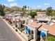 Aerial community view with red tile roofs, palm trees, and mountain views in the background at 8844 S 51St St # 3, Phoenix, AZ 85044