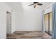 Bedroom featuring vaulted ceilings, a ceiling fan, wood-look floors, and sliding glass doors to a balcony at 8844 S 51St St # 3, Phoenix, AZ 85044