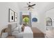 Inviting bedroom with a ceiling fan, balcony access, and decoratively framed arched window at 8844 S 51St St # 3, Phoenix, AZ 85044