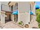 Exterior view highlighting stucco architecture, arched windows, blue awnings, and desert landscaping at 8844 S 51St St # 3, Phoenix, AZ 85044