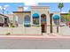 Charming two-story home featuring a stucco facade, arched windows, and blue awnings at 8844 S 51St St # 3, Phoenix, AZ 85044