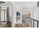 Bright hallway with wood floors, metal railing, and arched windows letting in natural light at 8844 S 51St St # 3, Phoenix, AZ 85044