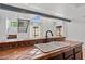 Kitchen sink with tile countertop featuring tile backsplash, wooden beam and staircase at 8844 S 51St St # 3, Phoenix, AZ 85044
