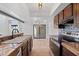 Bright kitchen featuring ample cabinetry, tile countertops, and modern appliances, connected to dining area at 8844 S 51St St # 3, Phoenix, AZ 85044