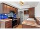 Well-equipped kitchen with stainless steel appliances, tile backsplash, and warm wood cabinets at 8844 S 51St St # 3, Phoenix, AZ 85044