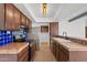 Kitchen featuring stainless steel appliances, tile backsplash, wooden cabinets and tile countertops at 8844 S 51St St # 3, Phoenix, AZ 85044