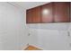 Laundry room featuring storage cabinets, neutral wall paint, and tile flooring at 8844 S 51St St # 3, Phoenix, AZ 85044