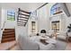 Bright living room with a fireplace, large windows, staircase, and comfortable seating area at 8844 S 51St St # 3, Phoenix, AZ 85044