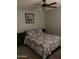 Comfortable bedroom with a ceiling fan and a queen sized bed with decorative pillows at 913 E Beryl Ave, Phoenix, AZ 85020