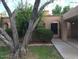 Charming home exterior featuring a covered driveway, desert landscaping, and an arched entryway at 913 E Beryl Ave, Phoenix, AZ 85020