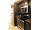 Updated kitchen featuring granite countertops, stainless steel appliances, and dark cabinetry at 913 E Beryl Ave, Phoenix, AZ 85020