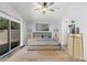 A staged bedroom featuring neutral colors, ceiling fan, and a large window at 924 E Baylor Ln, Gilbert, AZ 85296